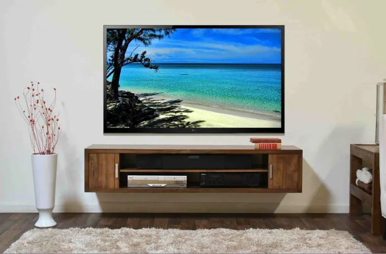 Professional TV wall mounting in London - technician installing a flat screen TV